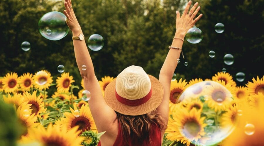 woman surrounded by sunflowers