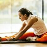 woman stretching on ground