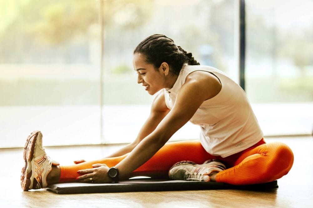 woman stretching on ground