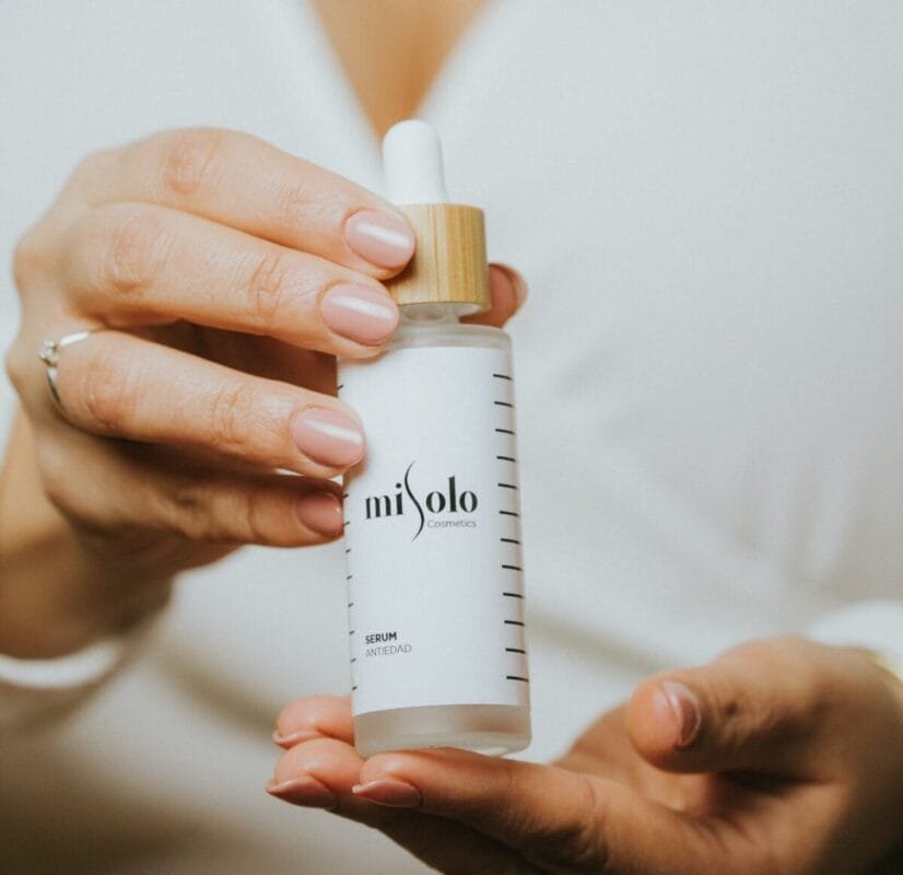 person holding white plastic bottle