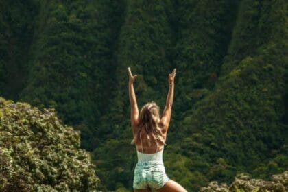 anonymous woman standing in vrksasana pose while practicing yoga in nature