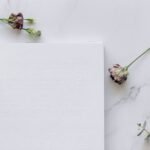 a braille book and dry flowers on the table