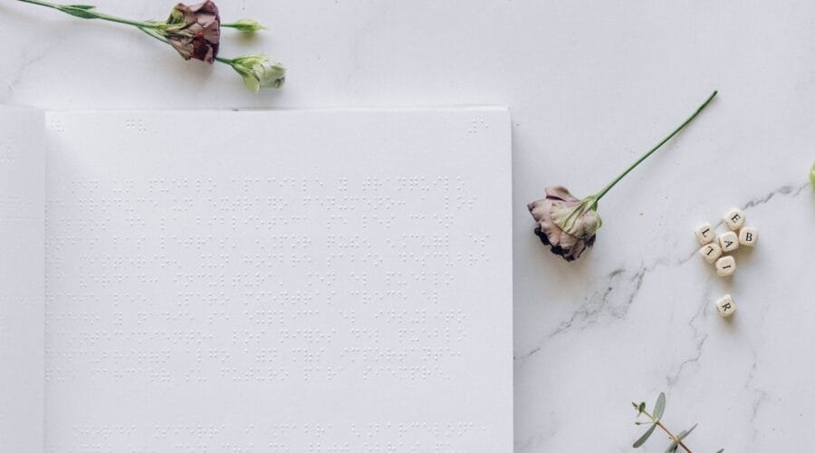 a braille book and dry flowers on the table