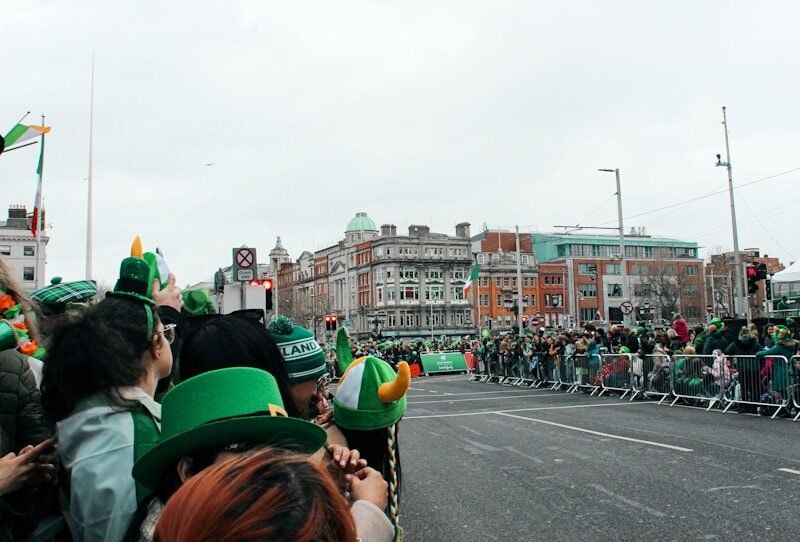 a group of people standing on the side of a road, san patricio, san patricio 2026, st patrick's day