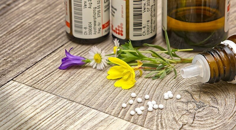 flores de bach, A bottle of medicine sitting on top of a wooden table